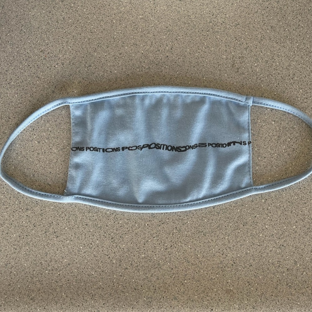 Ariana Grande positions face mask